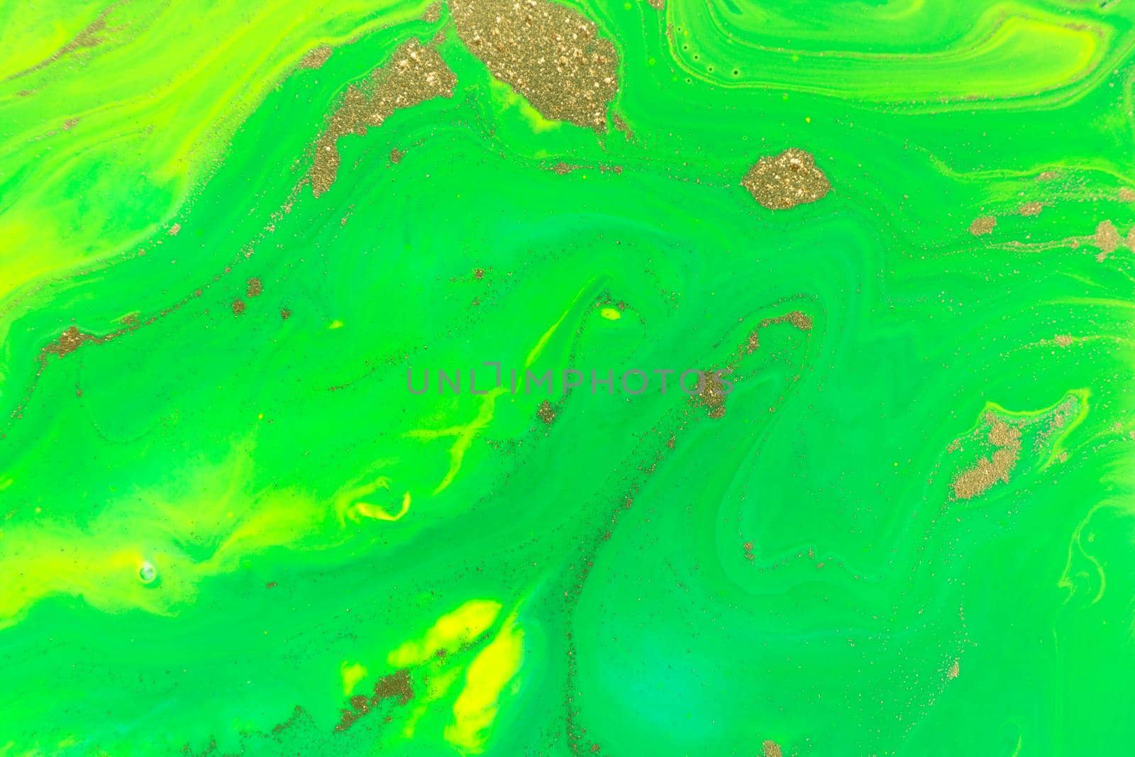 Gold spots on flow green vivid paints background. Abstract print.
