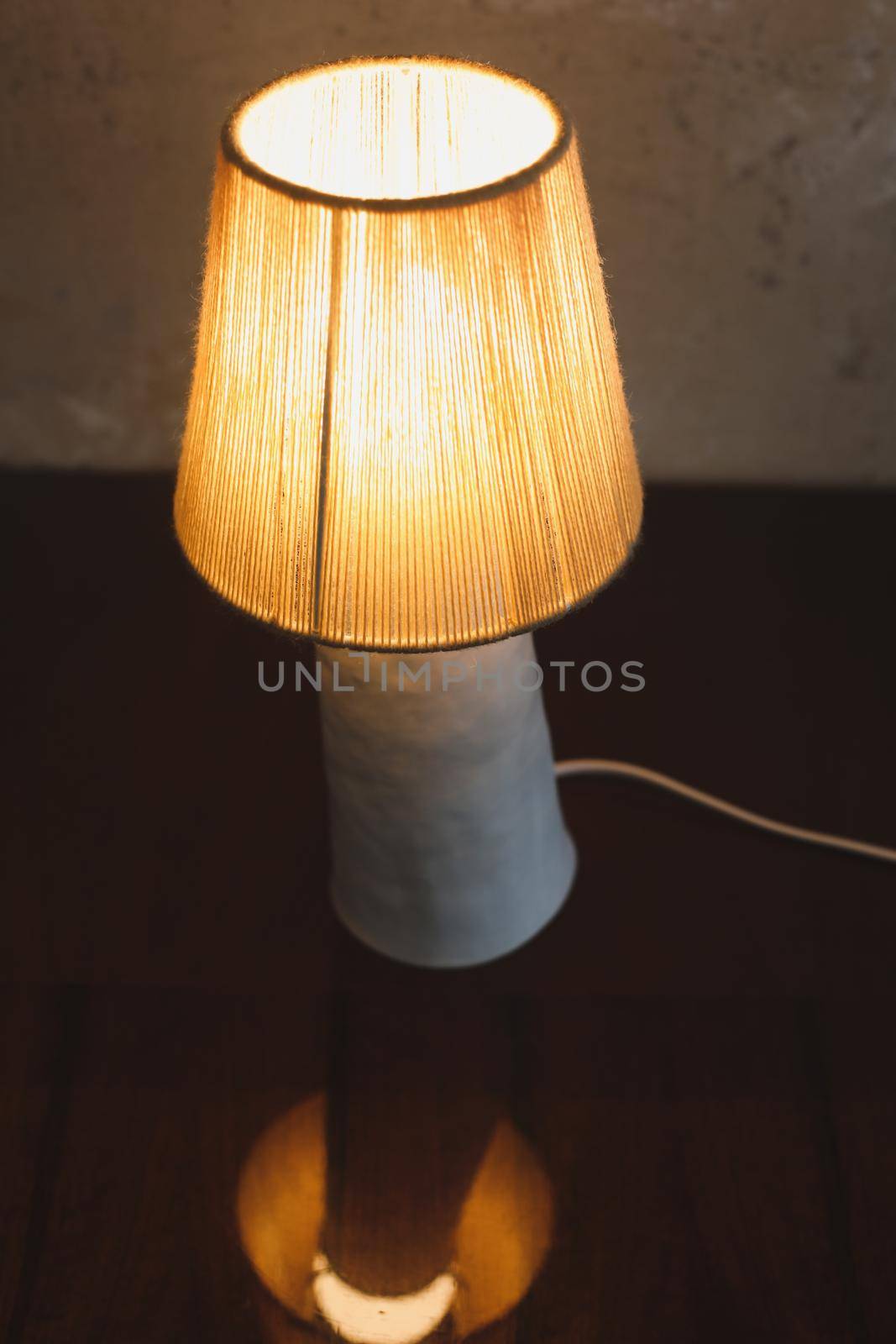 Stylish burning night lamp on table indoors. Light electric for interior home