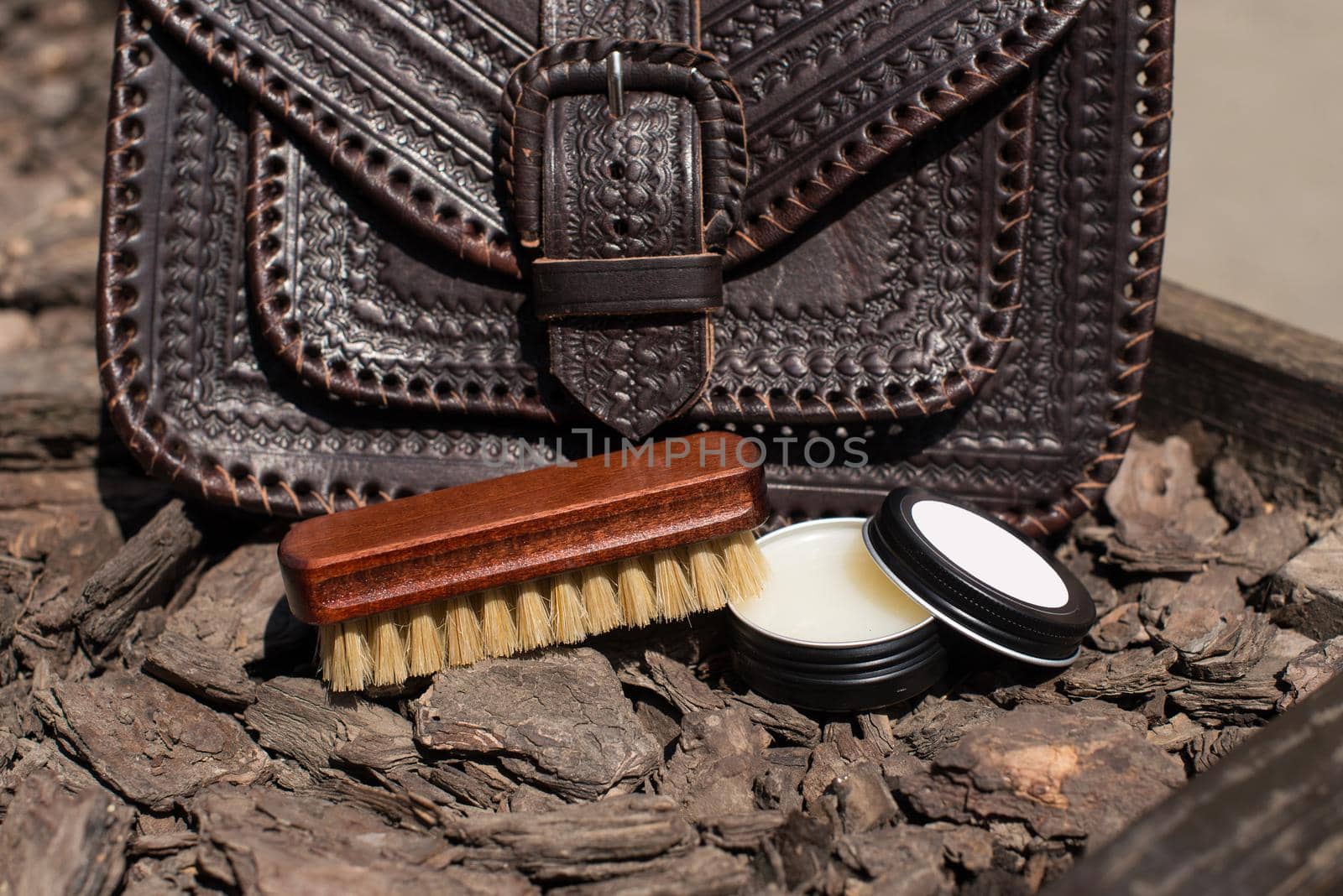 Wax and brush, leather maintenance concept. old genuine leather bag on a background. .