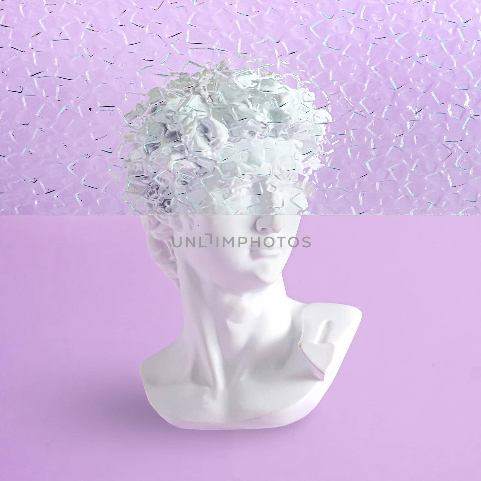 Bust of a statue of David on a purple background with fluted glass and part of the head is hidden. Contemporary minimal vaporwave concept.