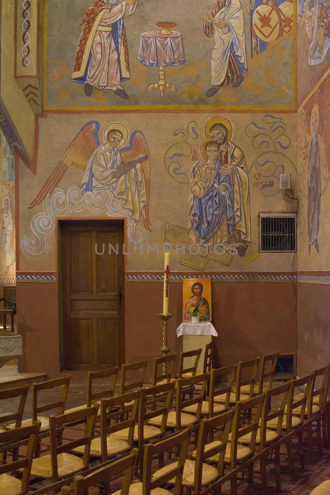 LE MANS, FRANCE - SEPTEMBER 17, 2017: Church St-Lazare in Le mans France with painted frescoes inside of Nikolay Greshniy and catholic stained-glass window