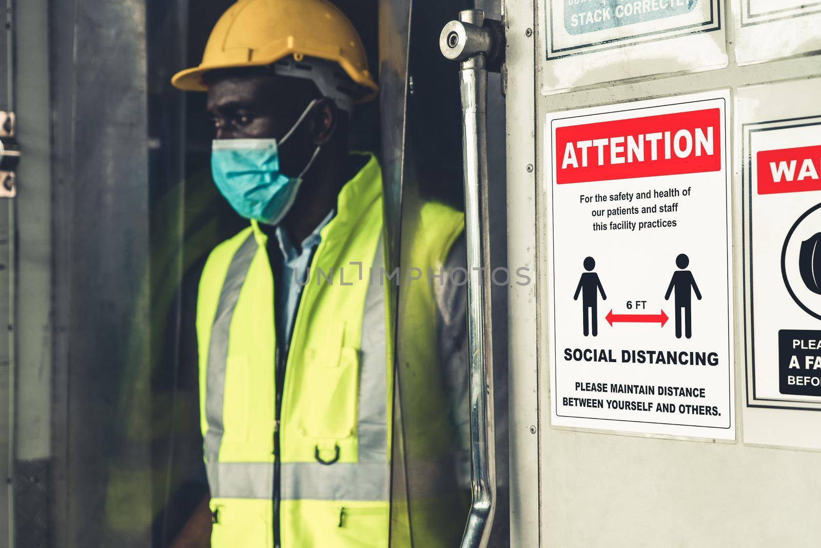 Caution sign in factory warning to industry labor worker to prevent Covid-19 Coronavirus spreading during job business reopening period after epidemic crisis . Working safely concept .
