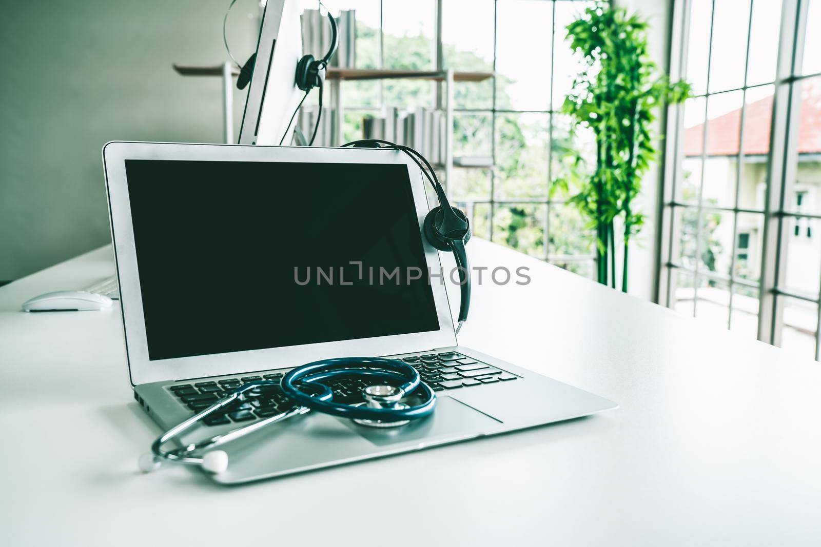 Headset and doctor equipment at clinic ready for actively support for patient by biancoblue