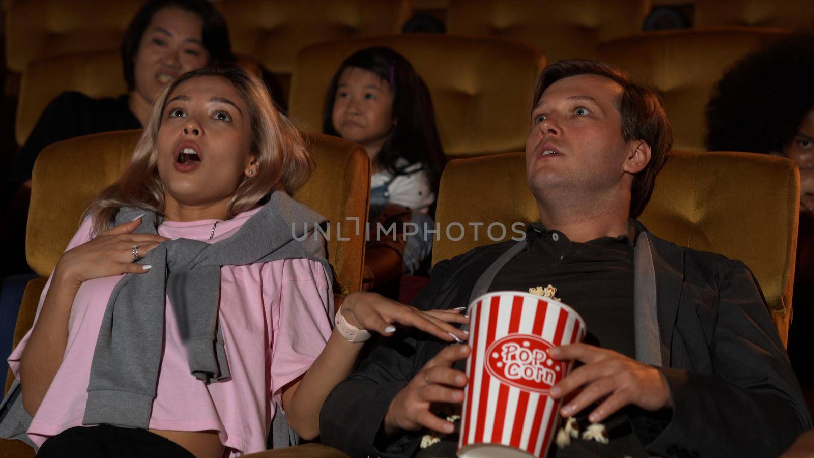 People audience watching movie in the movie theater cinema. Group recreation activity and entertainment concept.