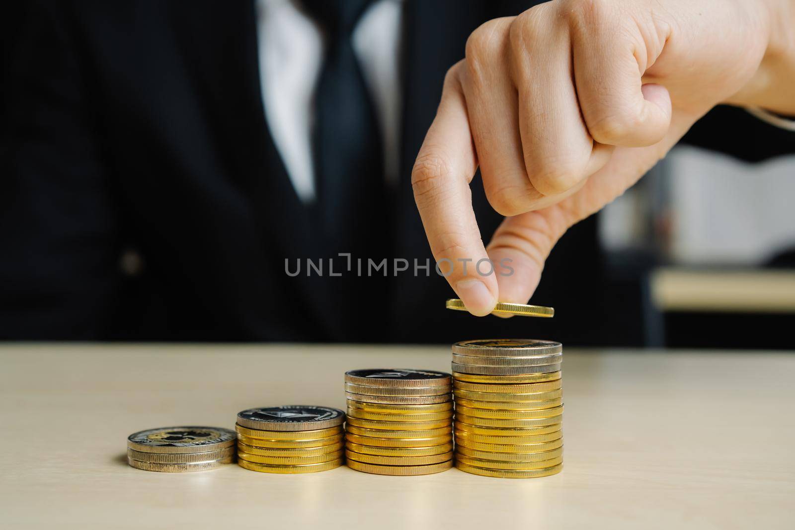 Businessman working with coin money currency. Concept of investment growth and money saving.
