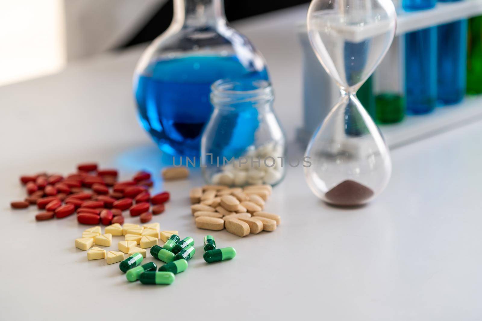 Colorful medicine pills and tablets in pharmaceutical lab. Concept of medical technology research and development for future cure of illness.
