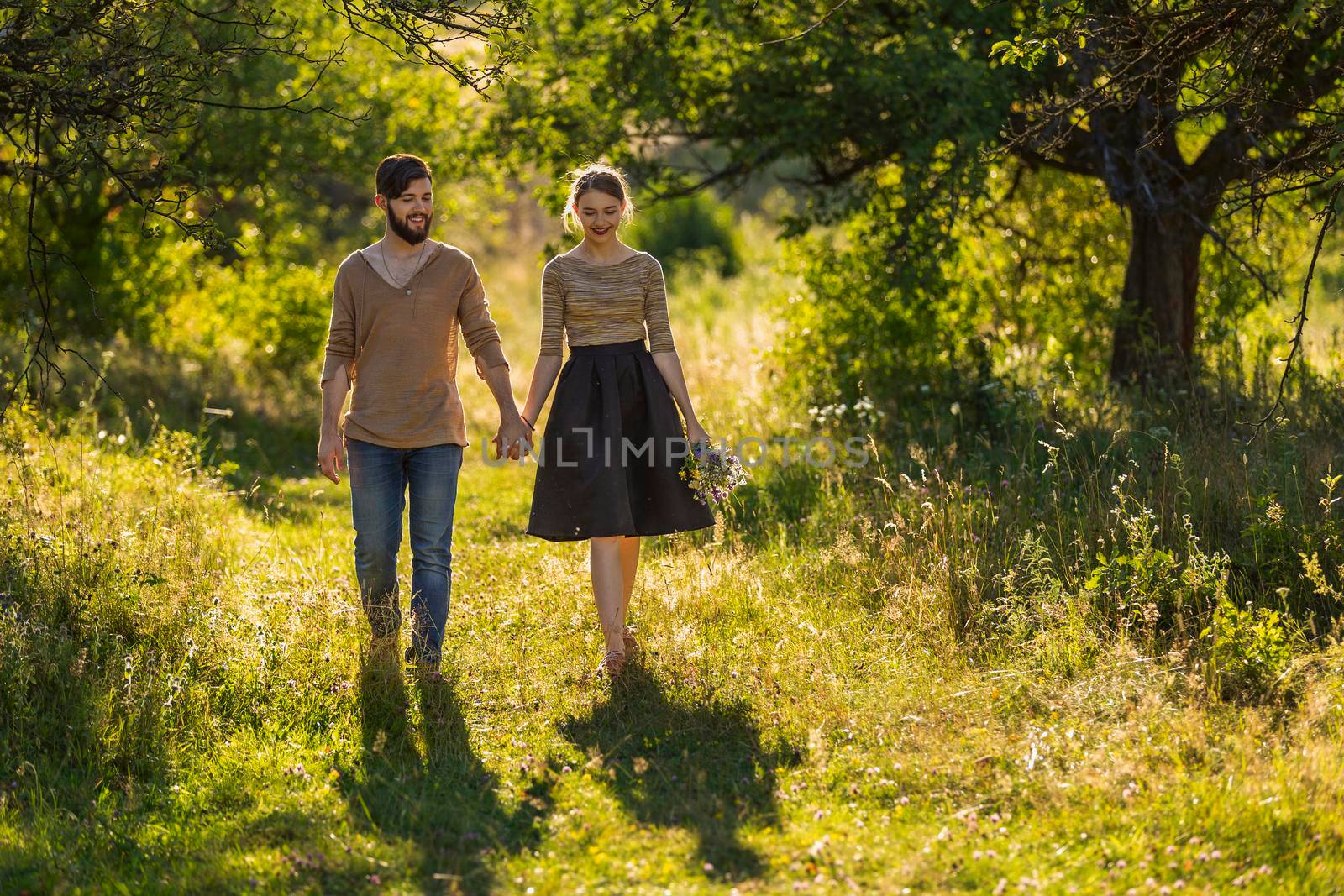 young couple walking in nature by zokov