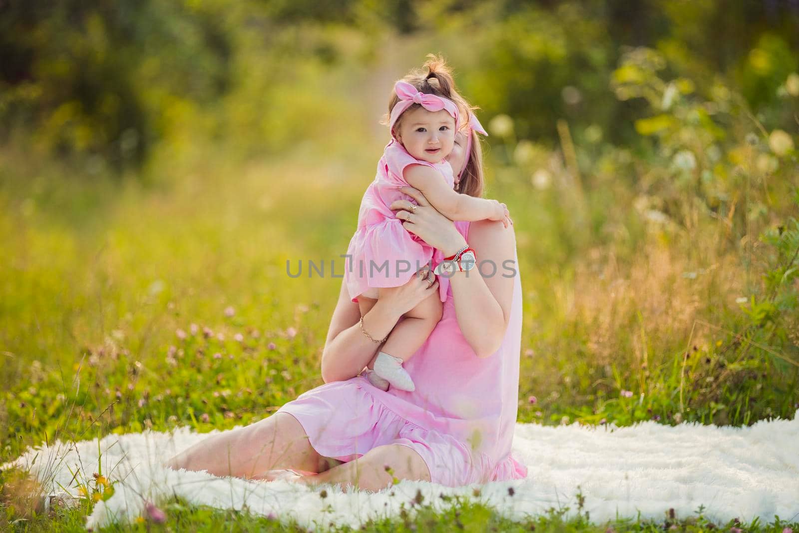 child in the arms of a mother who is in nature