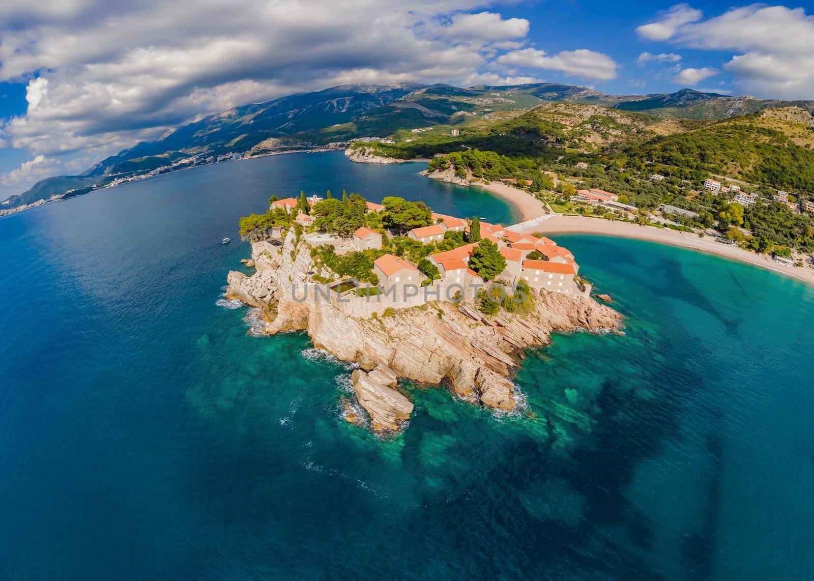 Aerophotography. View from flying drone. Panoramic view of Sveti Stefan island in Budva in a beautiful summer day, Montenegro. Top View. Beautiful destinations.