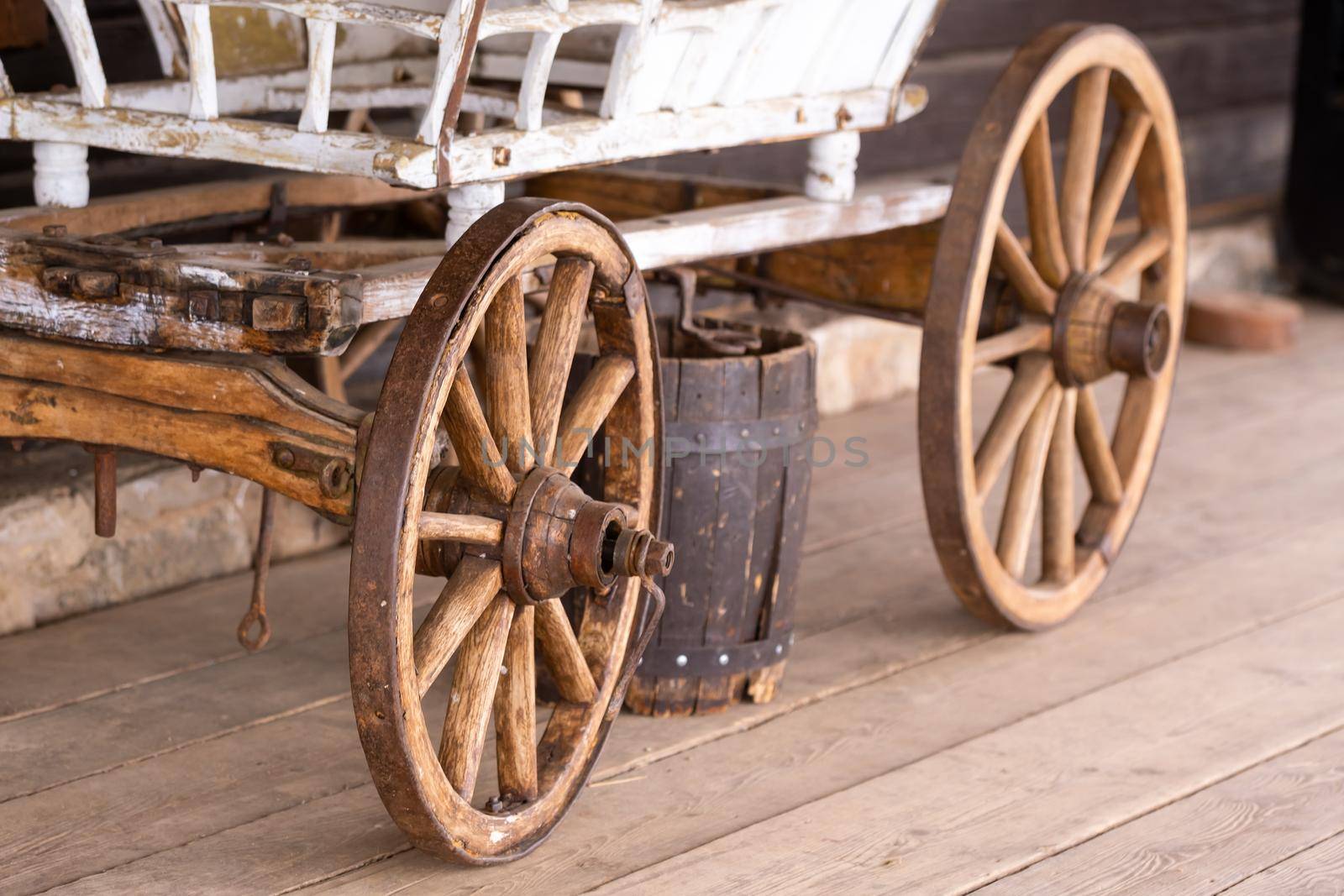 old wooden wheels are on the carriage at the ranch.