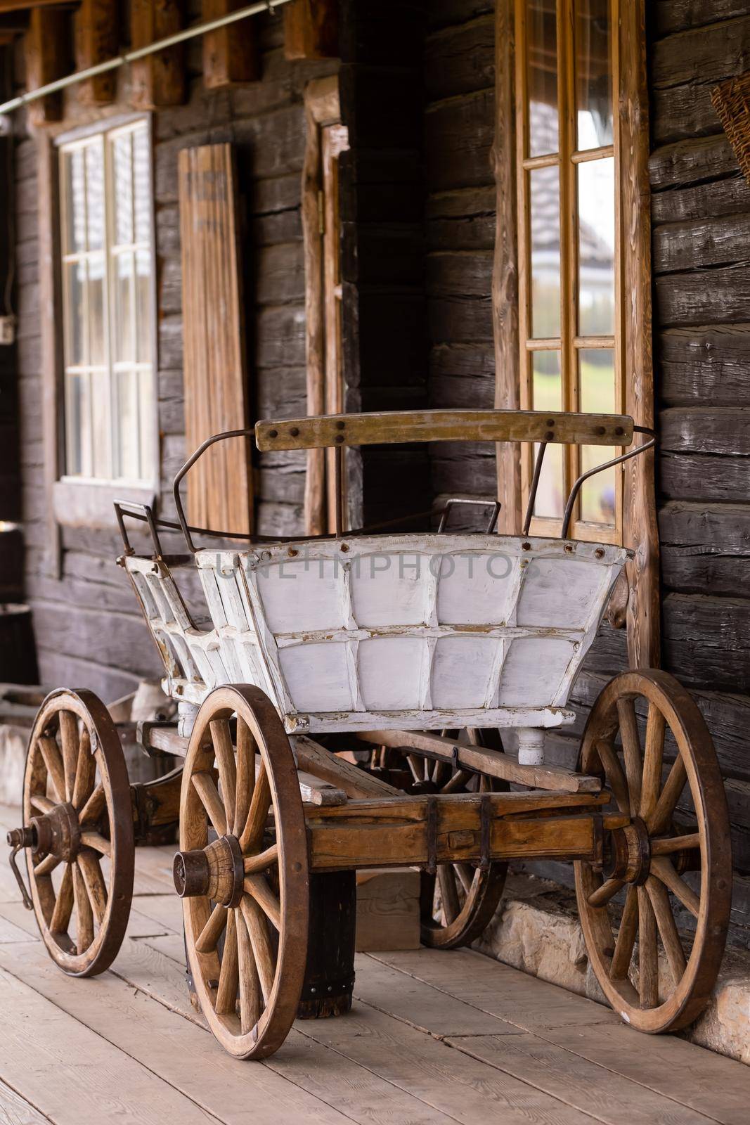 An empty antique carriage stands on a ranch in the wild West.