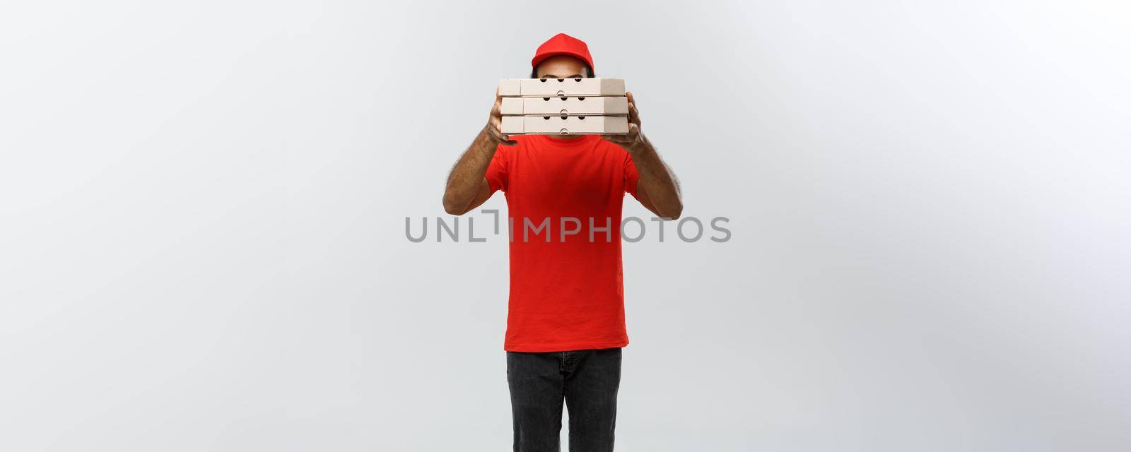 Delivery Concept - Portrait of Handsome African American Pizza delivery man. Isolated on Grey studio Background. Copy Space