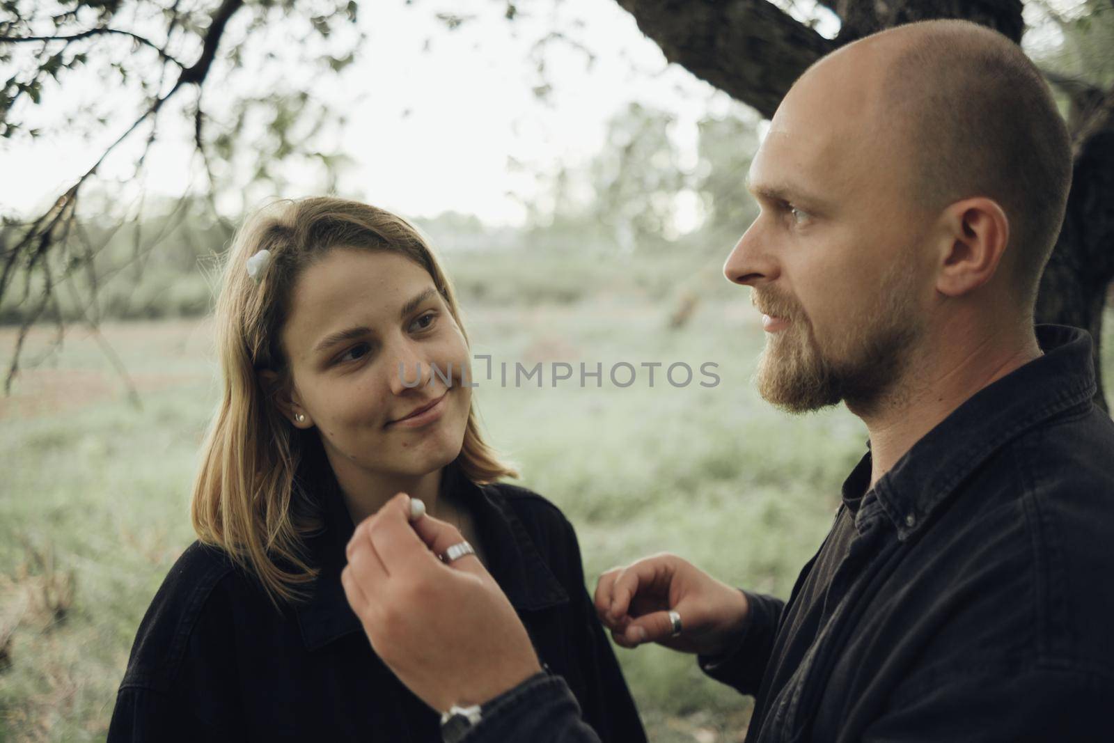 the guy places flowers in the hair of her beloved by Symonenko
