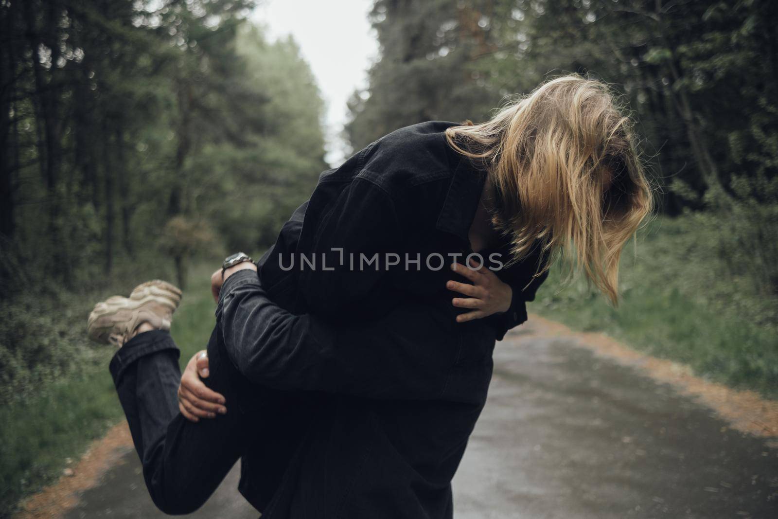 lovers hug in the forest in rainy weather