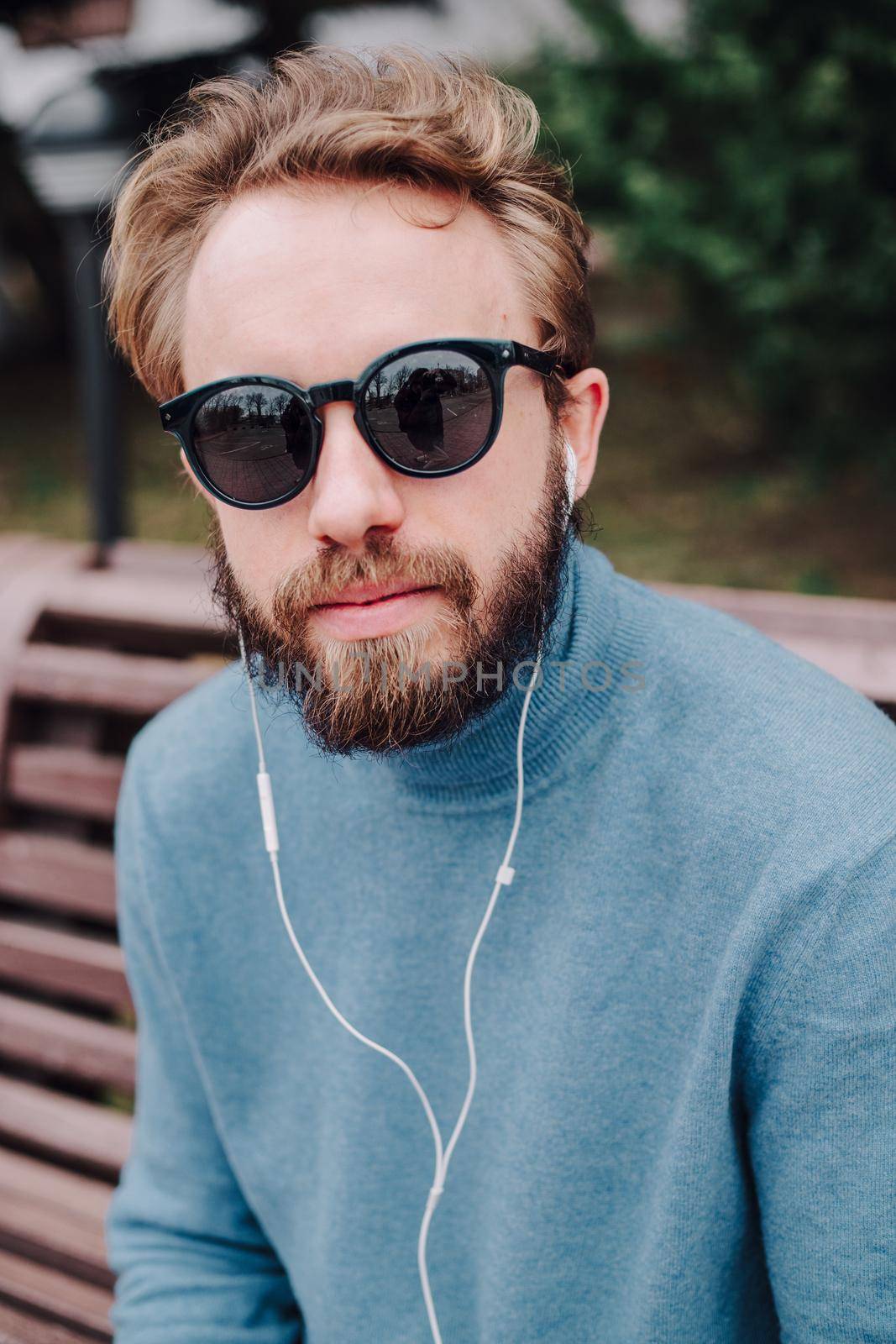 young hipster gay man listening music headphones by Symonenko