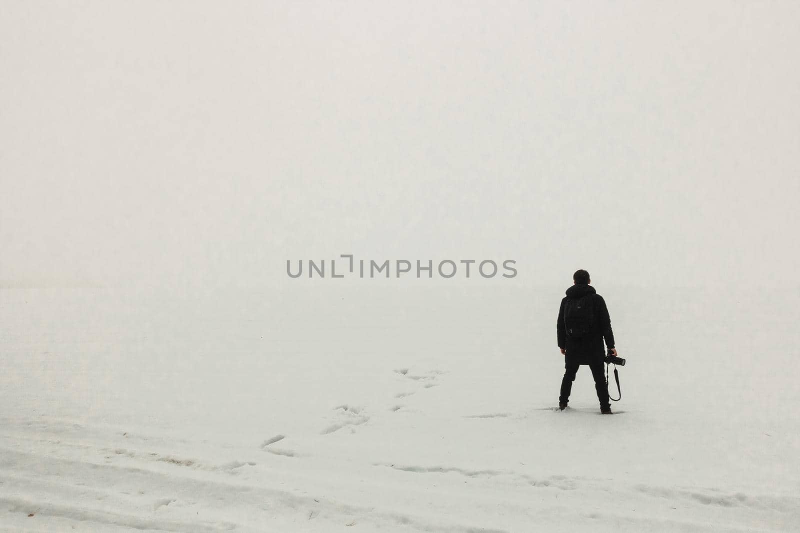 man standing on the ice misty morning simple minimalist photography one person by Symonenko