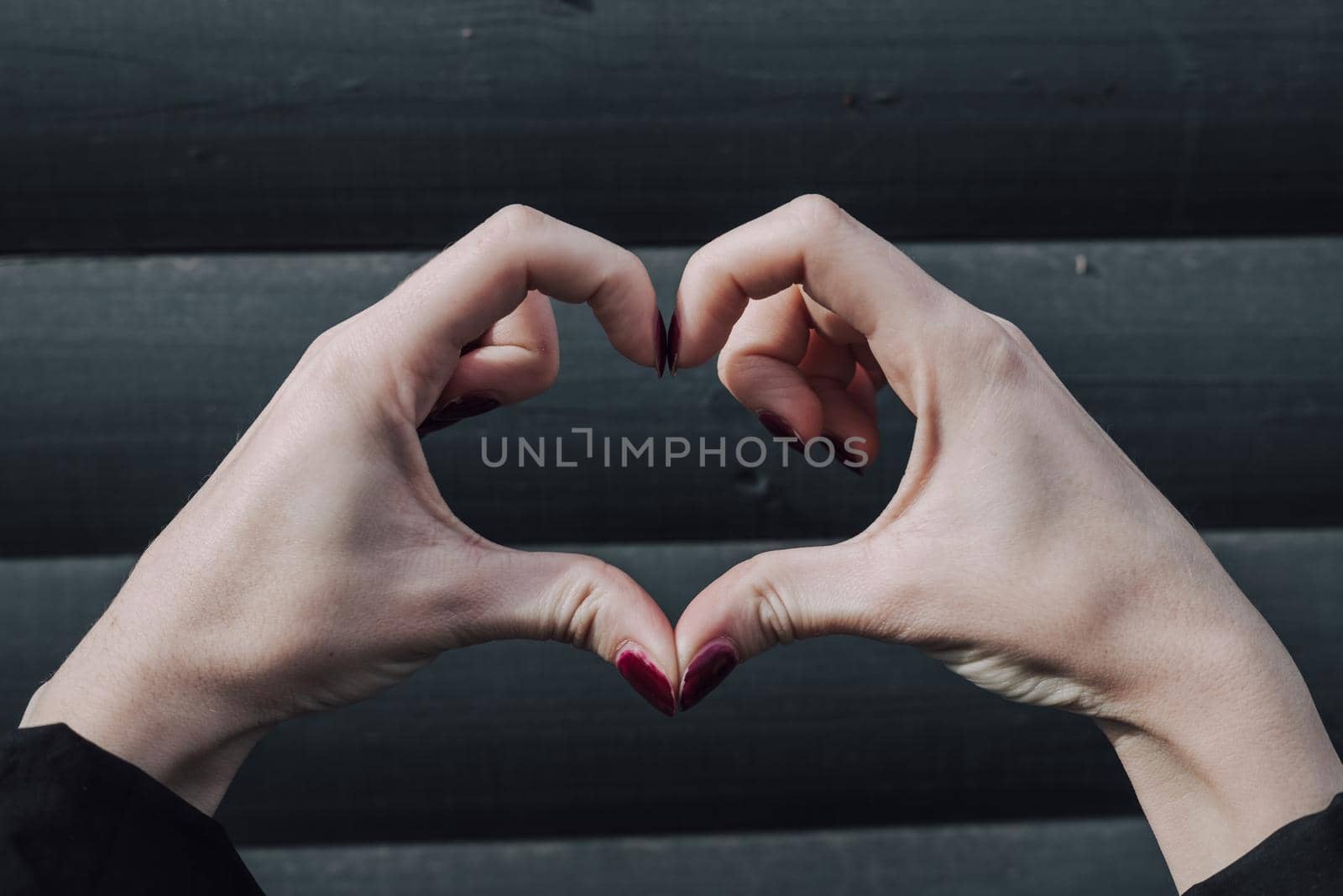 Perfect, nice, aged, old, pretty woman, showing heart figure with fingers, looking at camera, celebrating woman's day by Symonenko