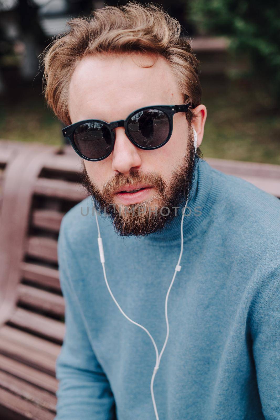 young hipster gay man listening music headphones by Symonenko
