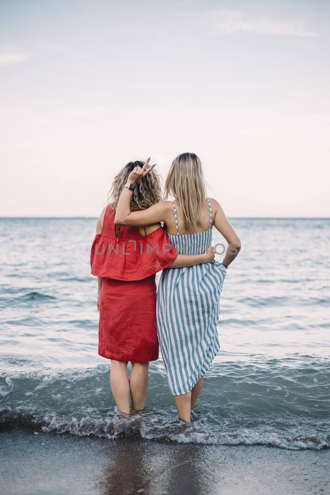 Woman at beach stay in a sea water by Symonenko