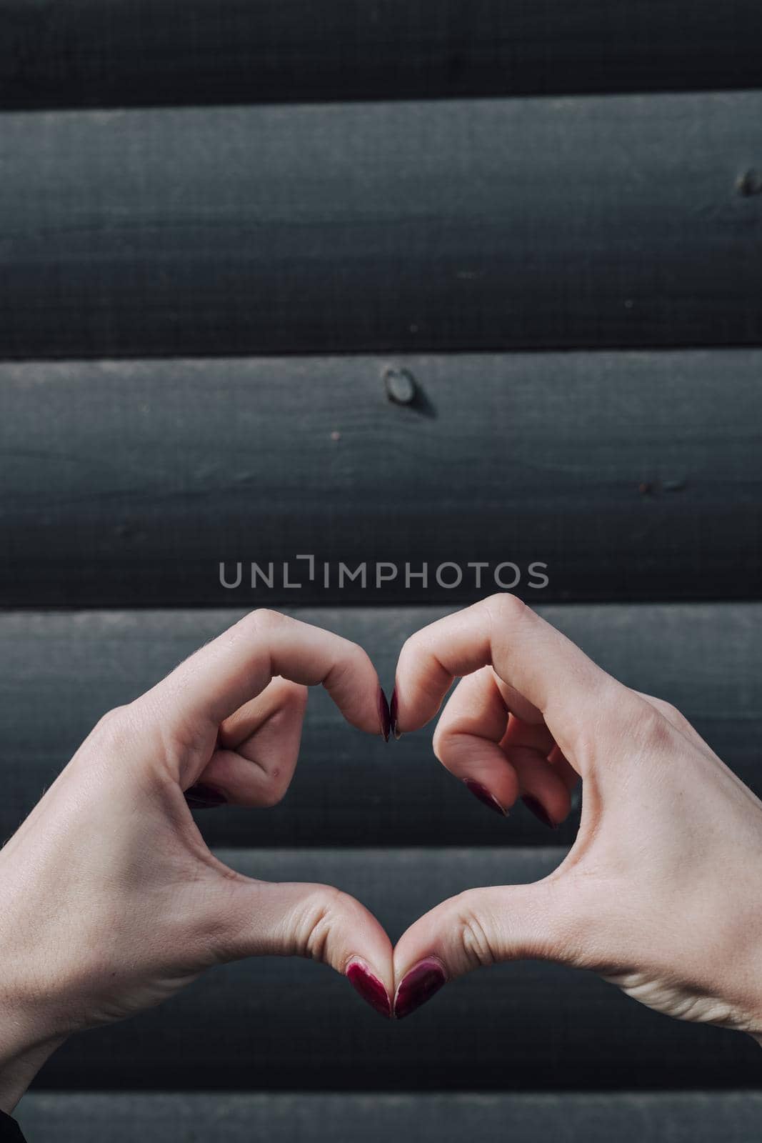 Perfect, nice, aged, old, pretty woman, showing heart figure with fingers, looking at camera, celebrating woman's day, standing over gray background