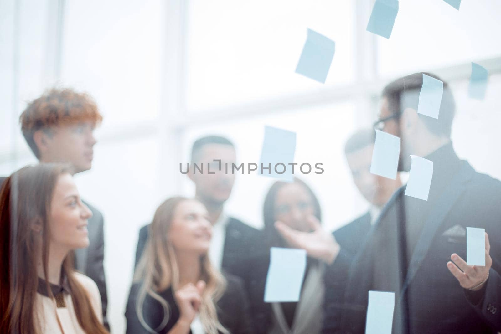 close up. Manager and working group standing in front of glass office wall