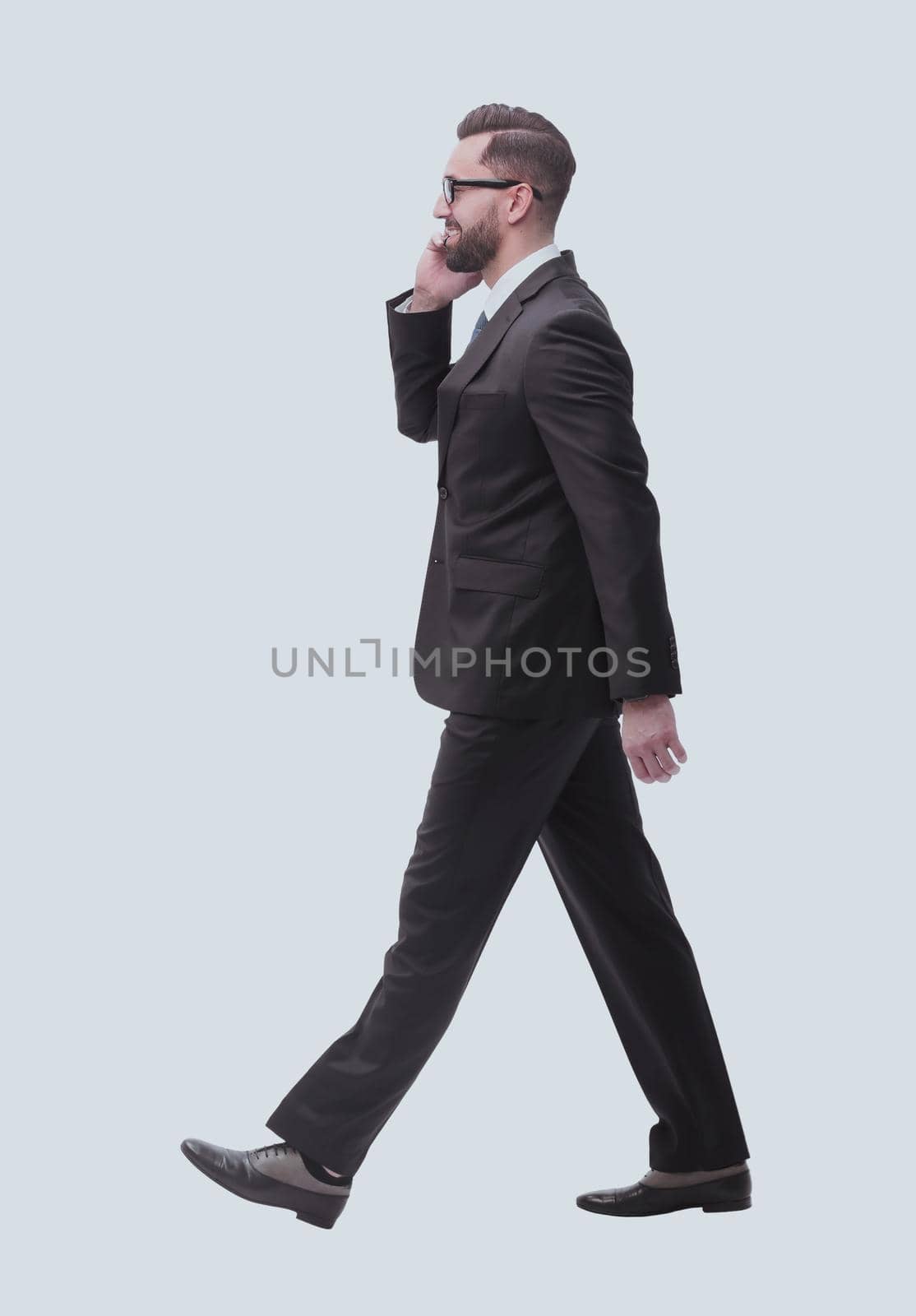 side view. businessman talking on his smartphone . isolated on white background