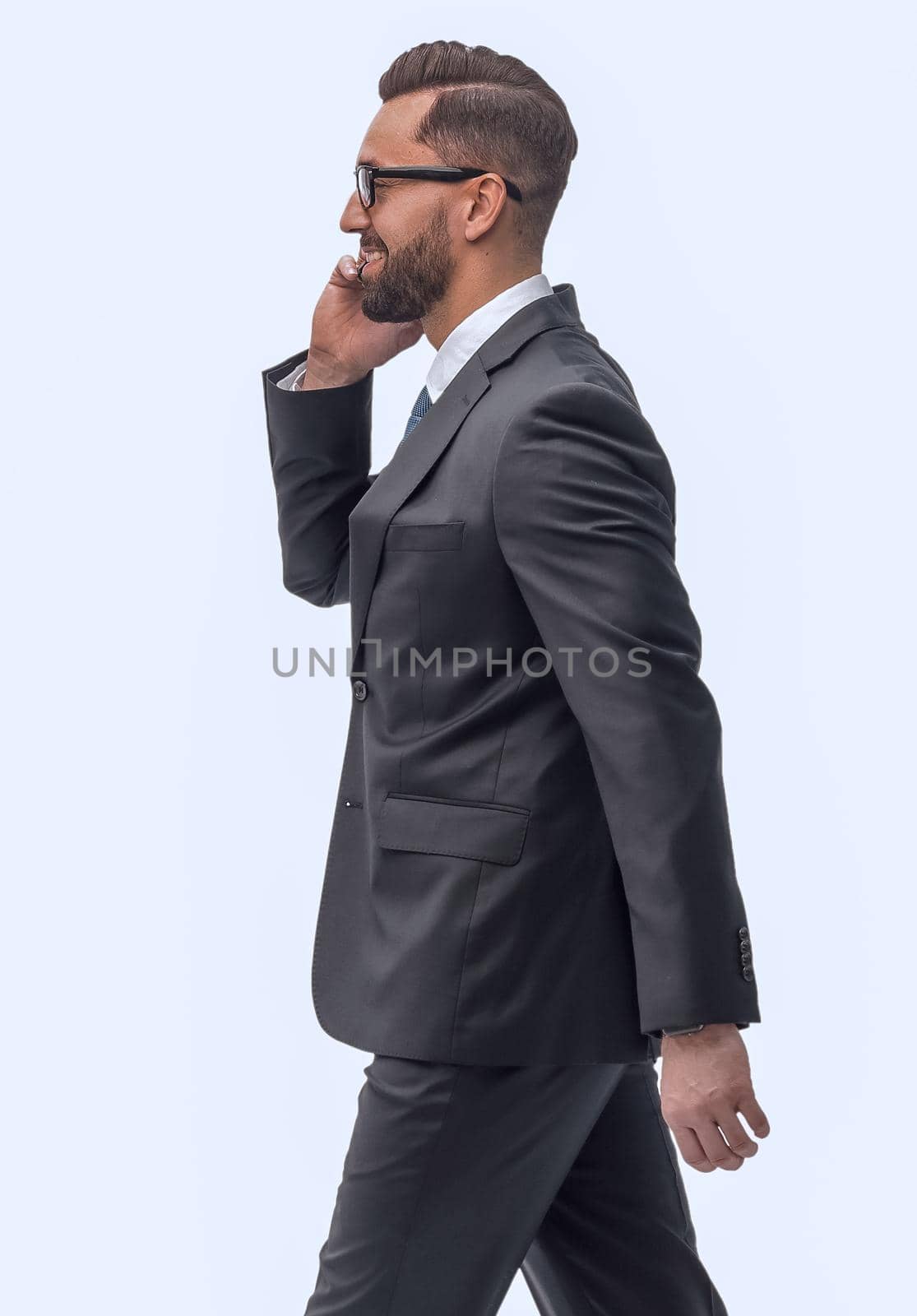 side view. businessman talking on his smartphone . isolated on white background
