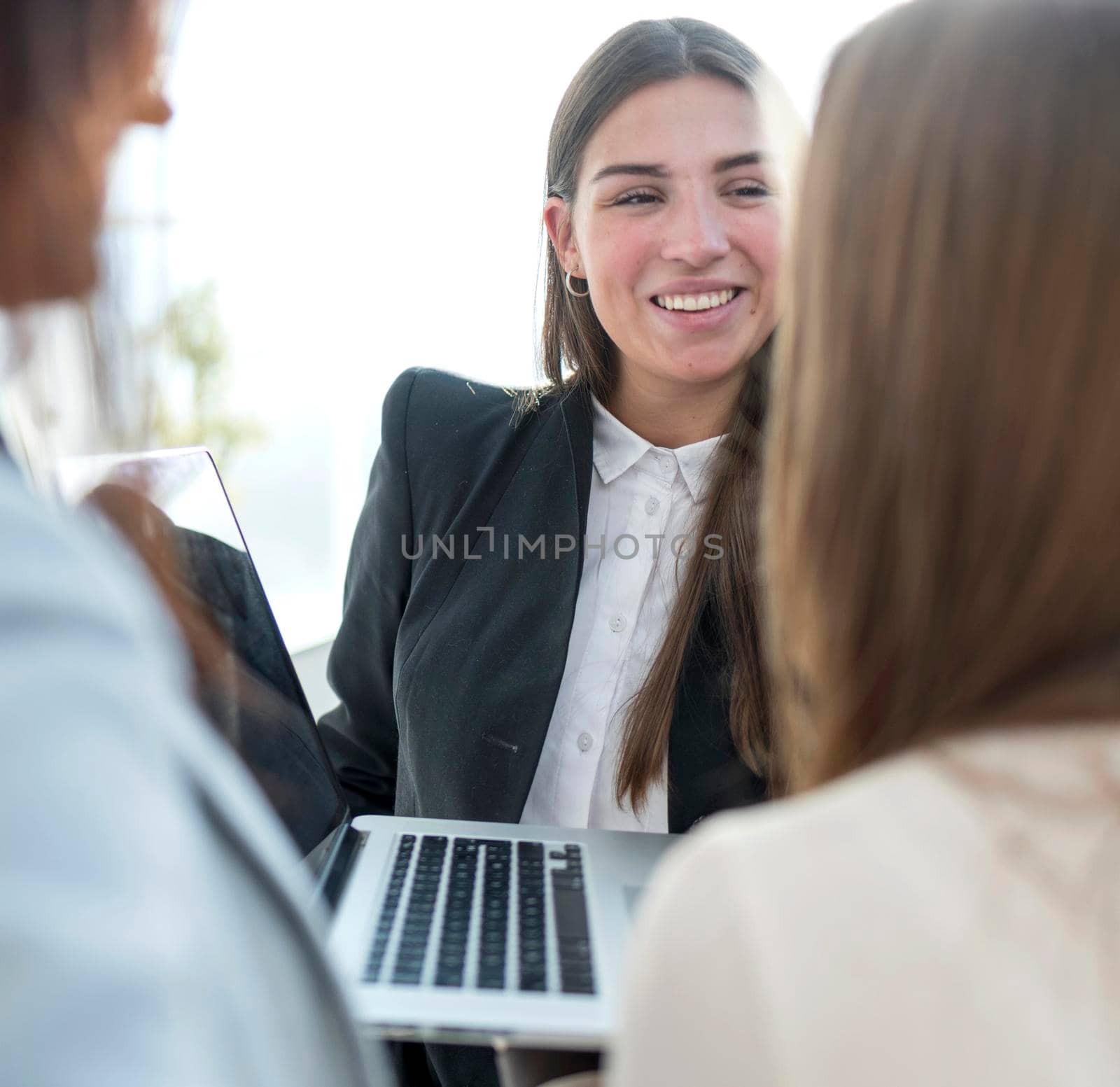 close up. a group of young employees standing near an open laptop