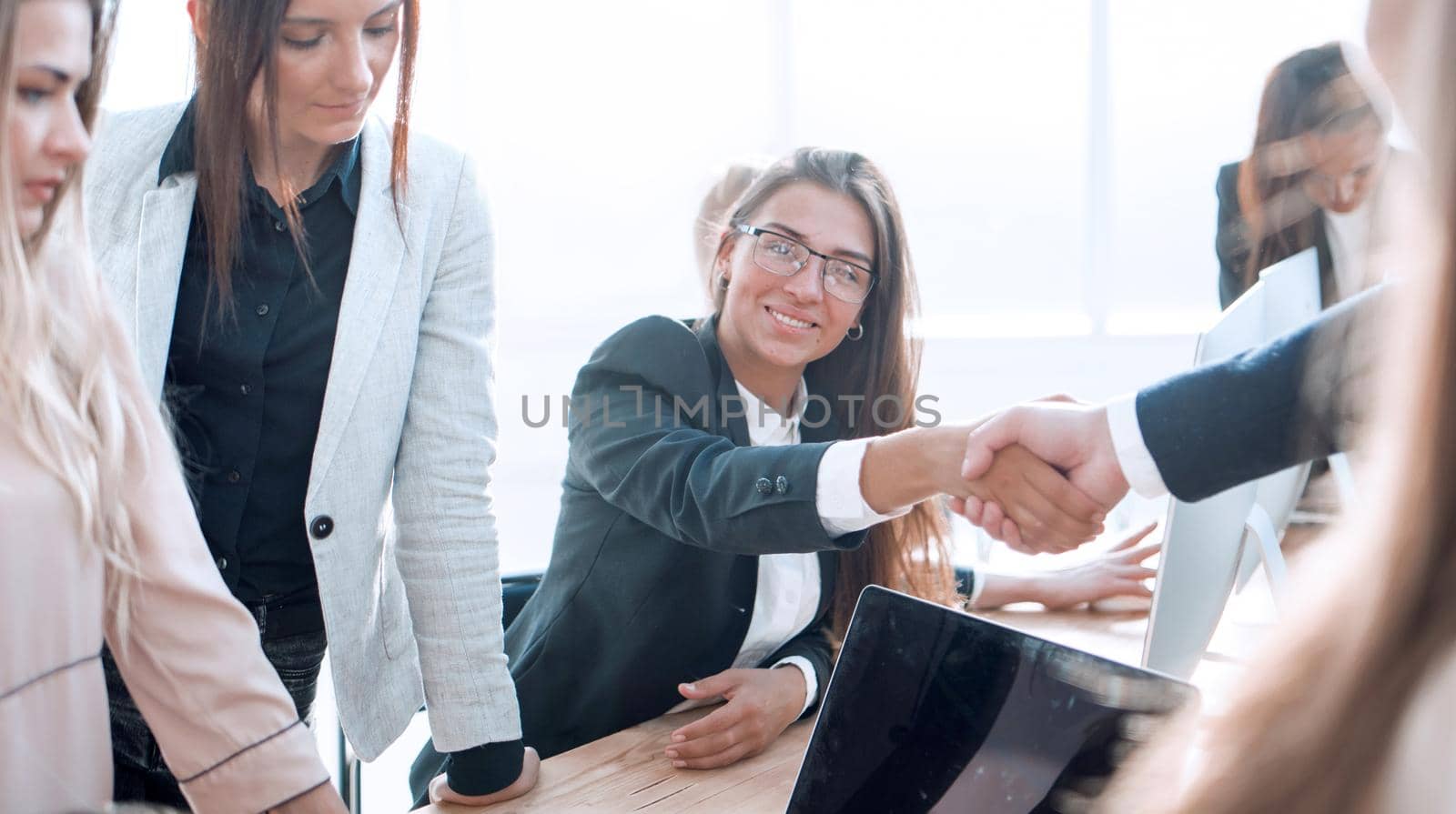 close up. happy business colleagues shaking hands with each other. success concept