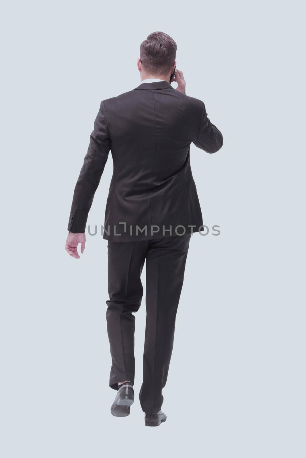 modern businessman talking on mobile phone. isolated on white by asdf