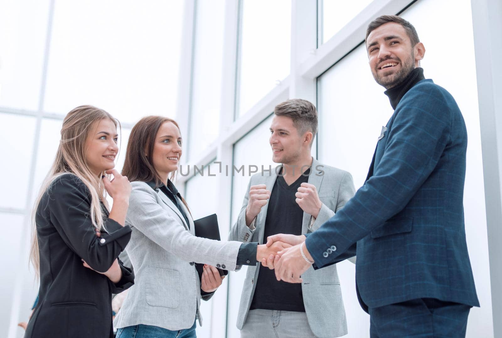 close up. young businesswoman shaking hands with her business partner