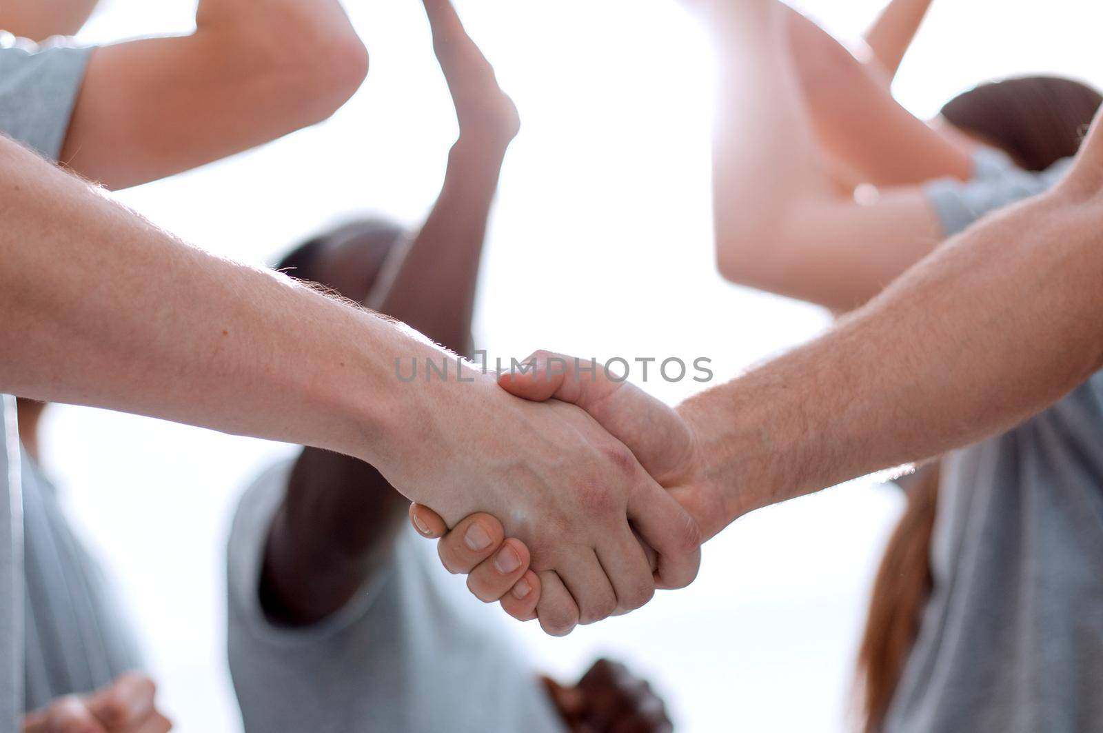 confident group of young men pointing ahead. photo with copy space