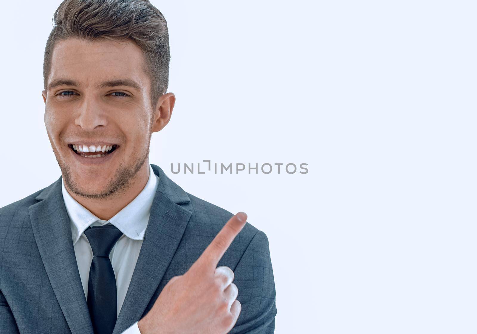 Smiling business man which pointing away and looking at camera