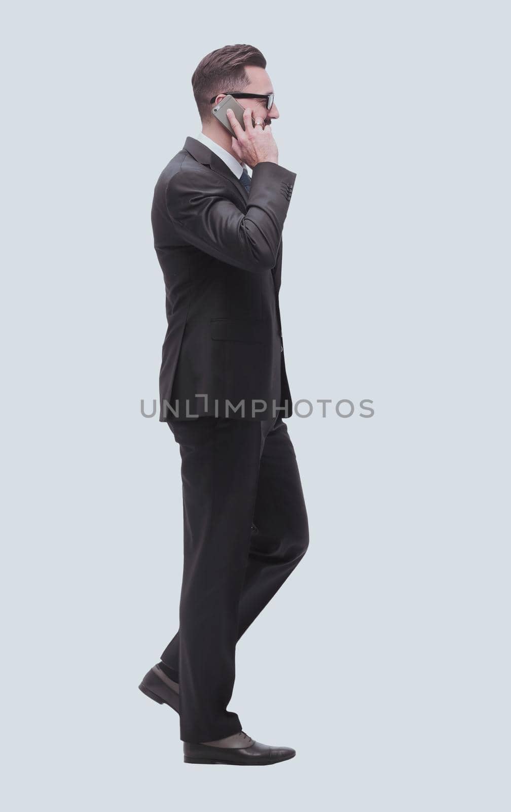 businessman talking on his smartphone . isolated on white by asdf