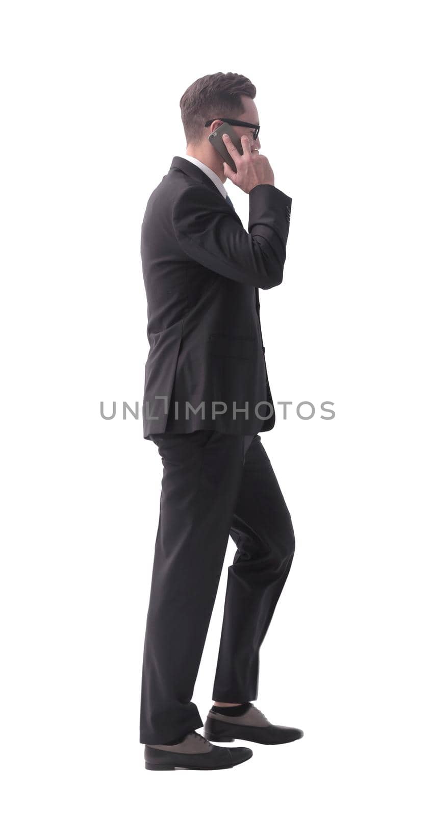 businessman talking on his smartphone . isolated on white by asdf