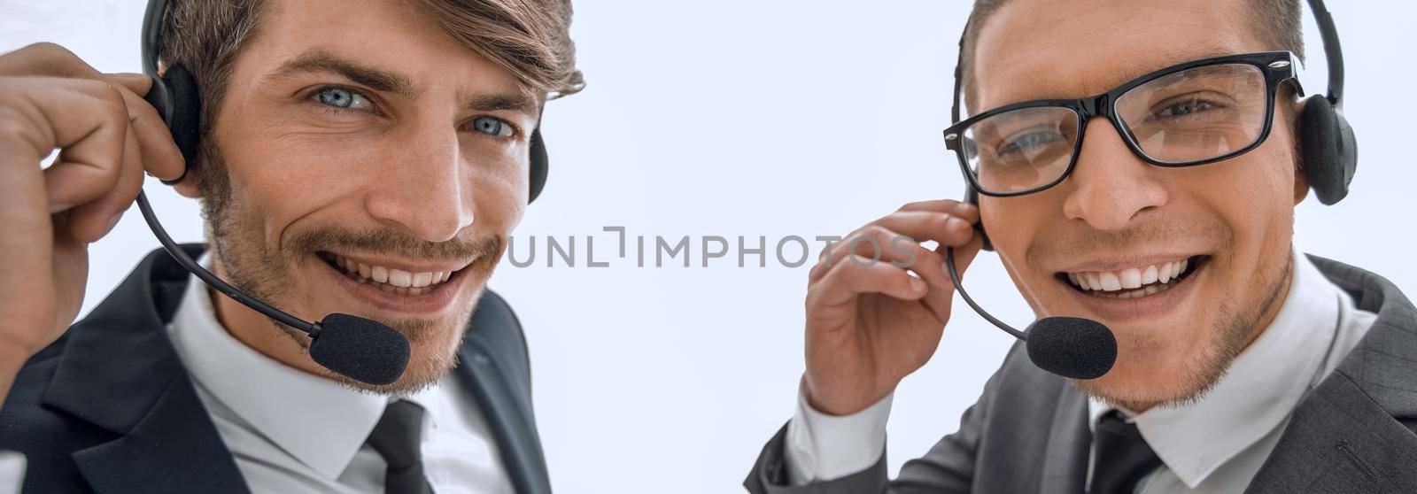 Smiling businessman talking on headset against a white backgroun by asdf