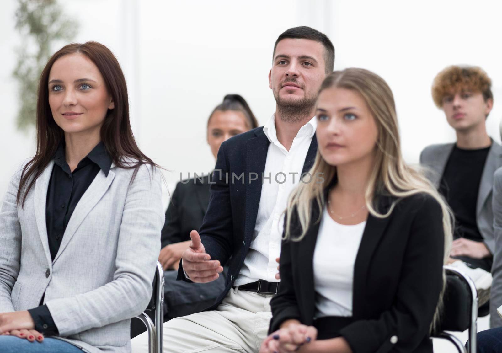 audience applauds during a business seminar. concept of success by asdf