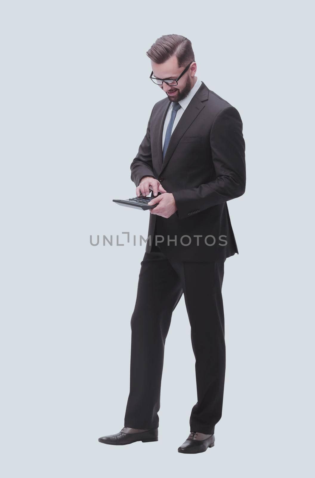 Confident businessman counting on calculator. isolated on white background