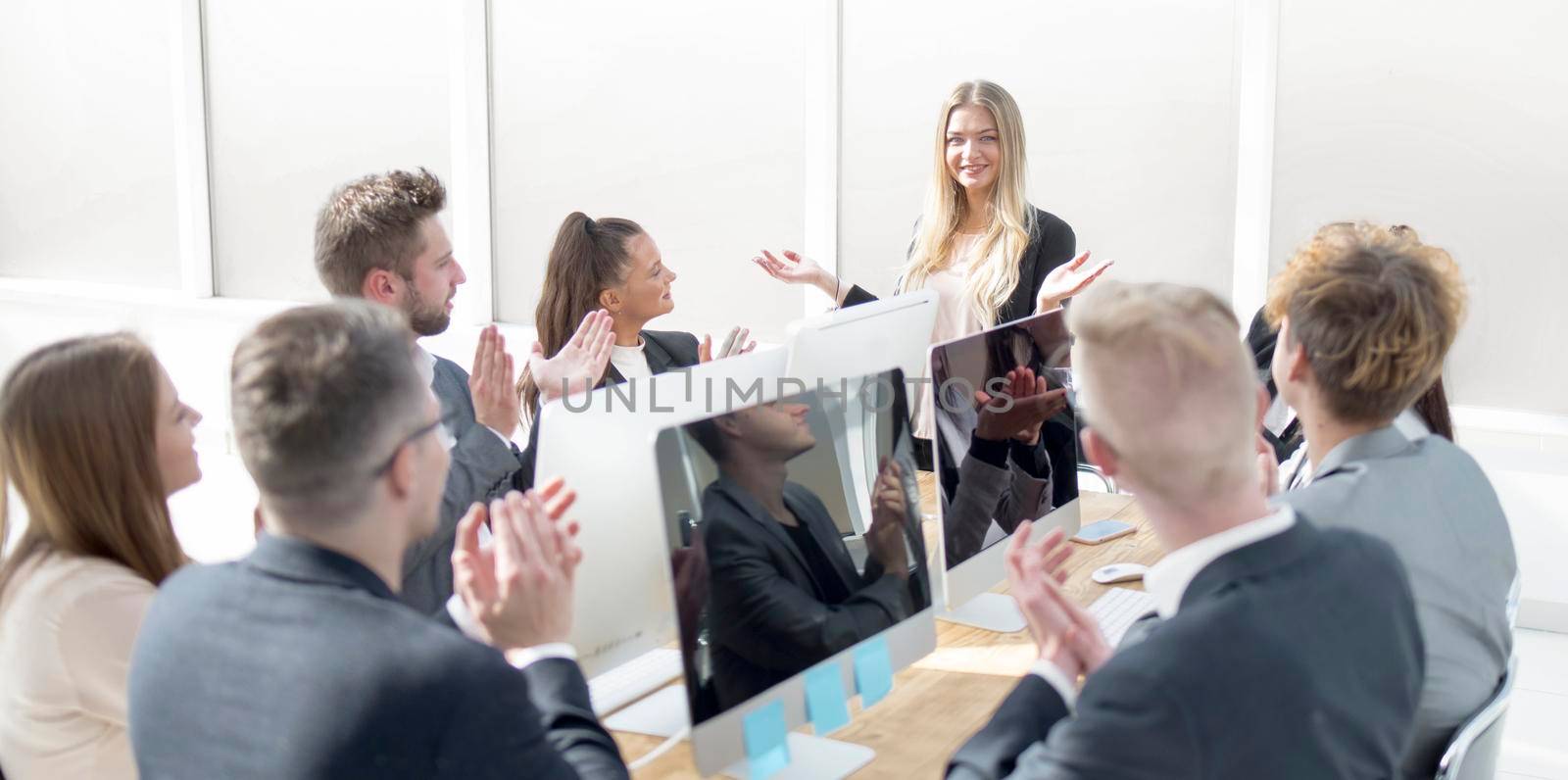 business team applauding the speaker at a working meeting. the concept of teamwork