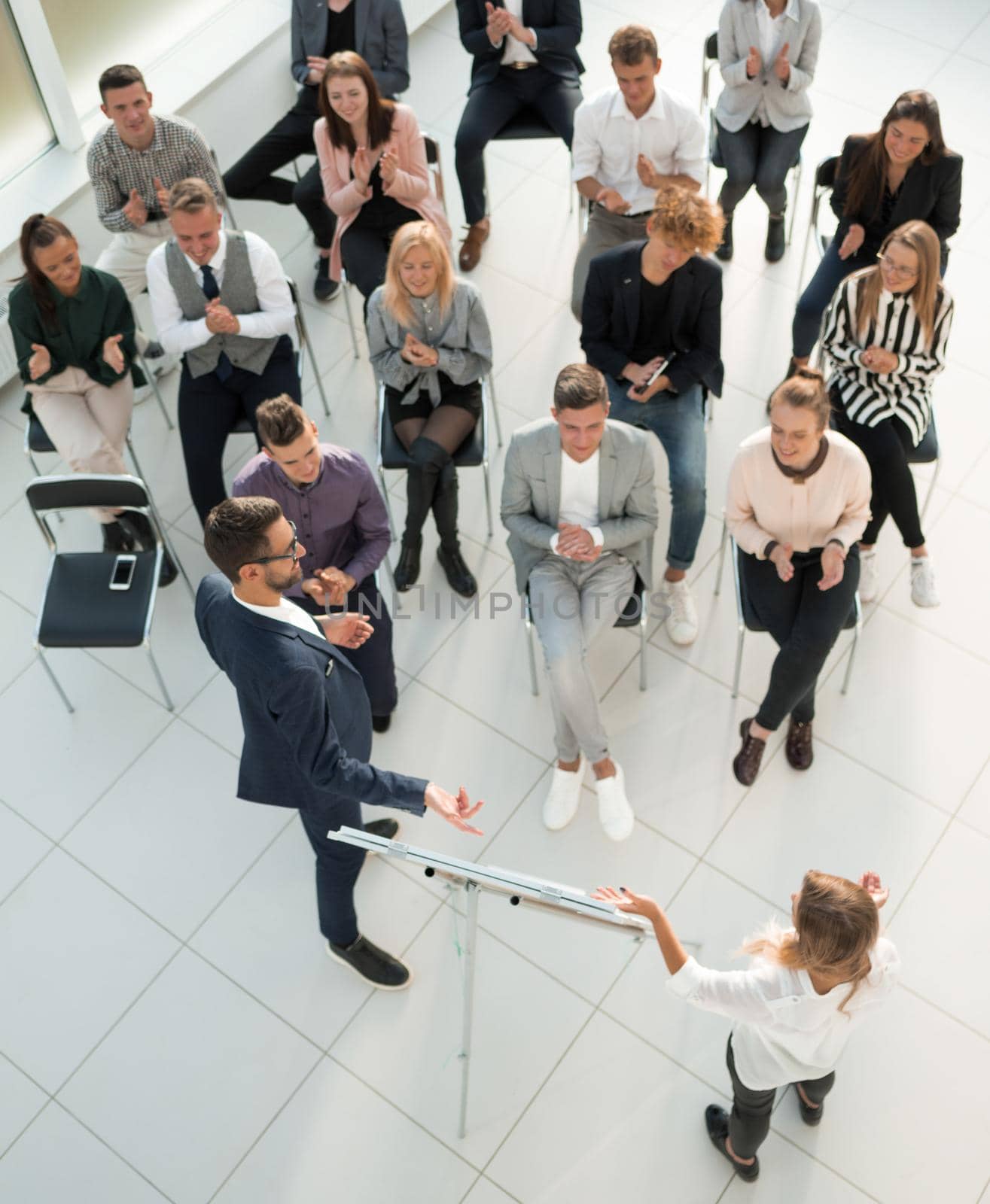 top view. listeners applauding the speaker at a business seminar. by asdf