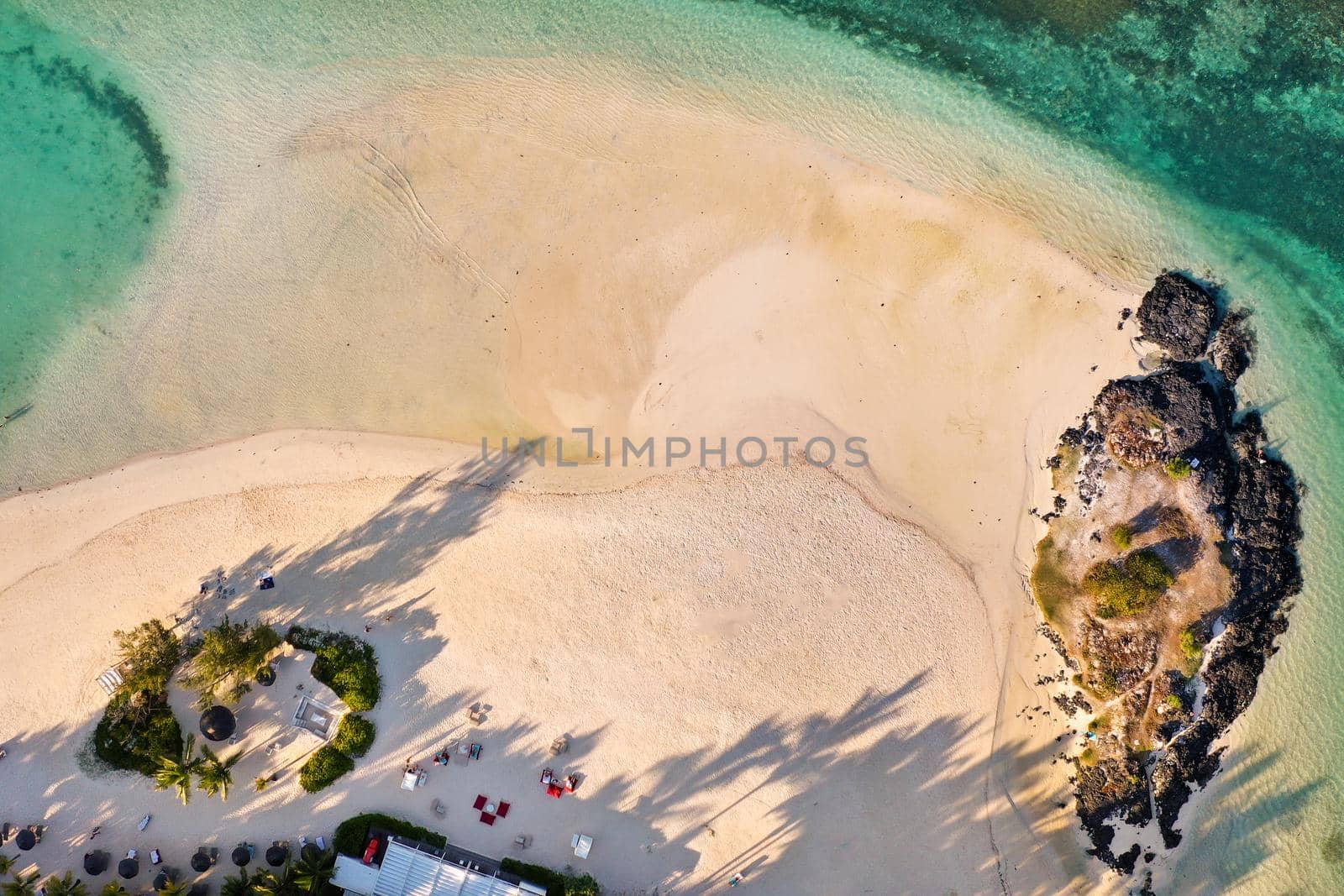View from the height of the east coast of the island of Mauritius. Flying over the turquoise lagoon of the island of Mauritius in the area of Bel Mare