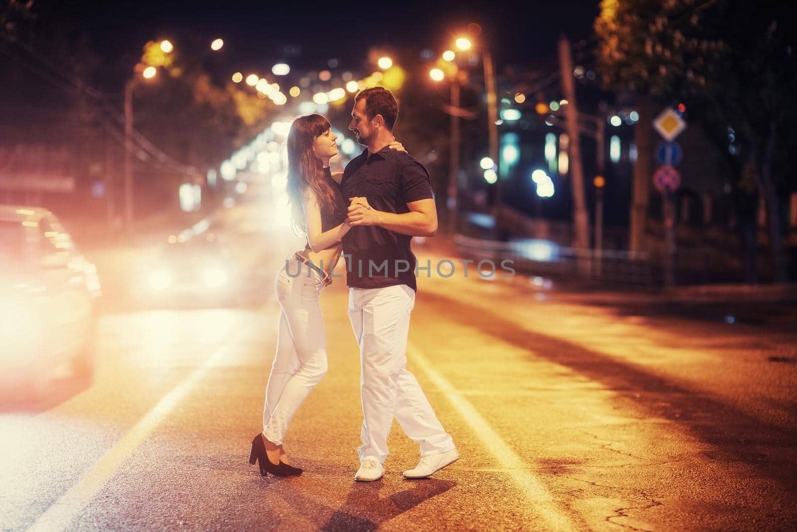 young couple dancing on the road. by Standret