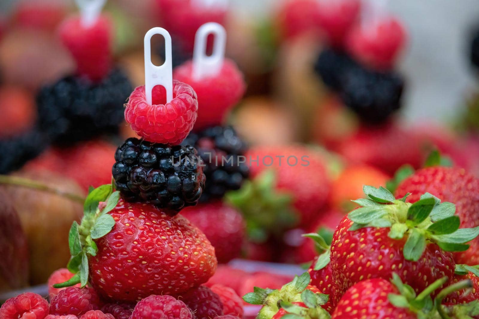 Selective focus. fresh strawberries, raspberries and blackberries in a glass. Summer Beach Food.