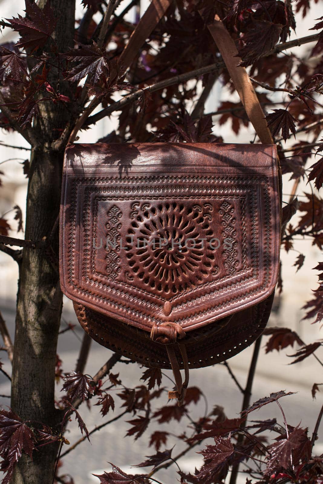 small burgundy women's leather bag with a carved pattern by Ashtray25