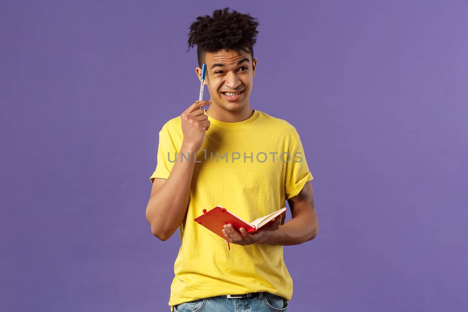 Young troubled male student studying, doing homework, scratch head indecisive and unsure, facing complicated task, dont know how solve equation, grimacing, holding notebook, thinking.