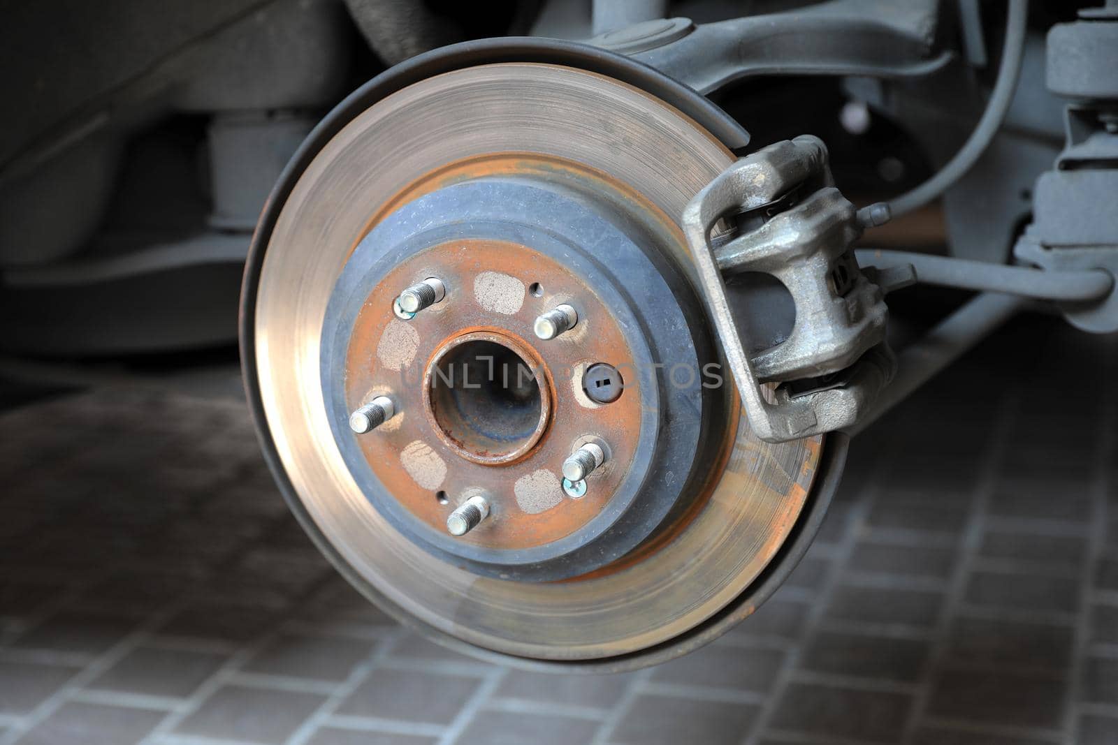 Disk brake and caliper in process of new tire replacement by drpnncpp