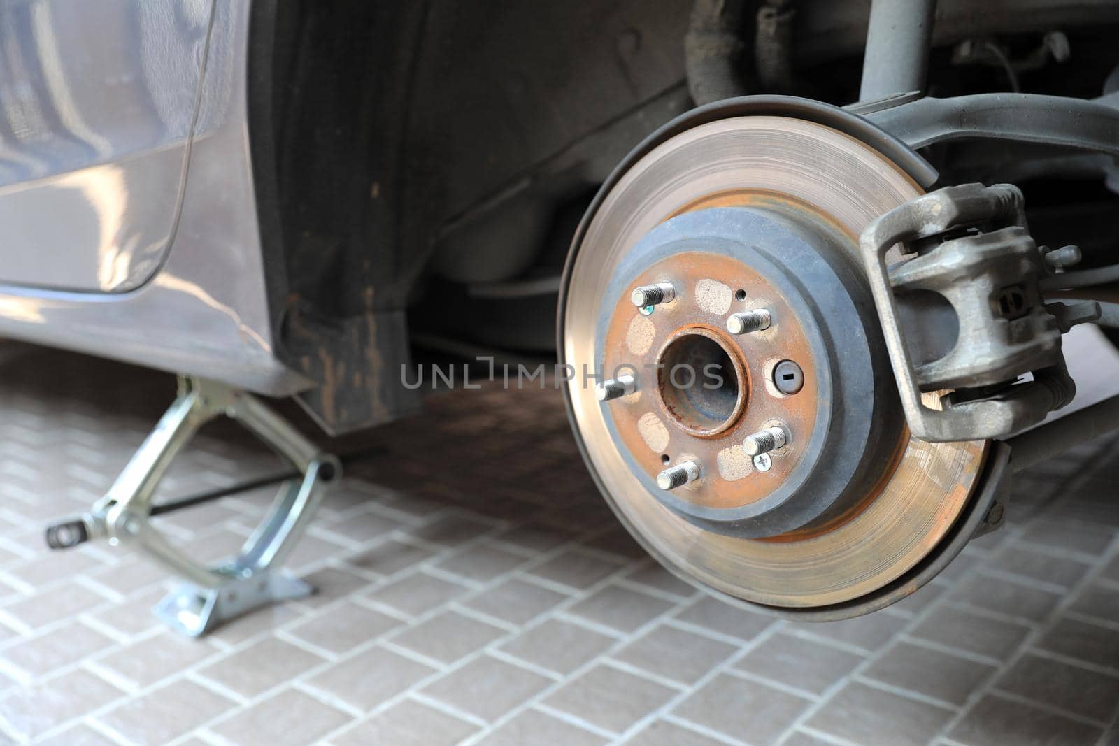 Disk brake and caliper in process of new tire replacement by drpnncpp
