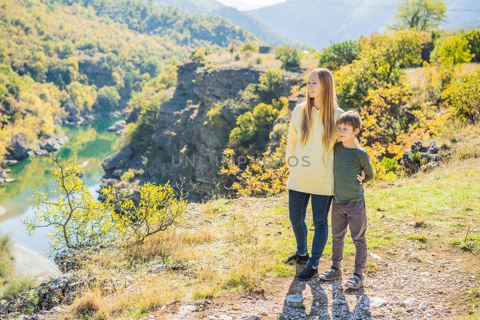 Montenegro. Mom and son tourists on the background of Clean clear turquoise water of river Moraca in green moraca canyon nature landscape. Travel around Montenegro concept by galitskaya