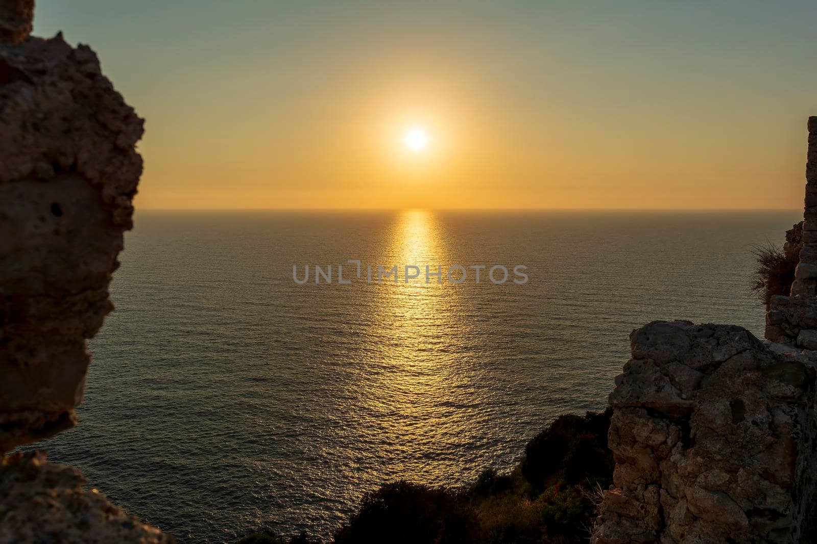 Beautiful sunset above the sea from Palaiokastro castle of ancient Pylos. Greece by ankarb