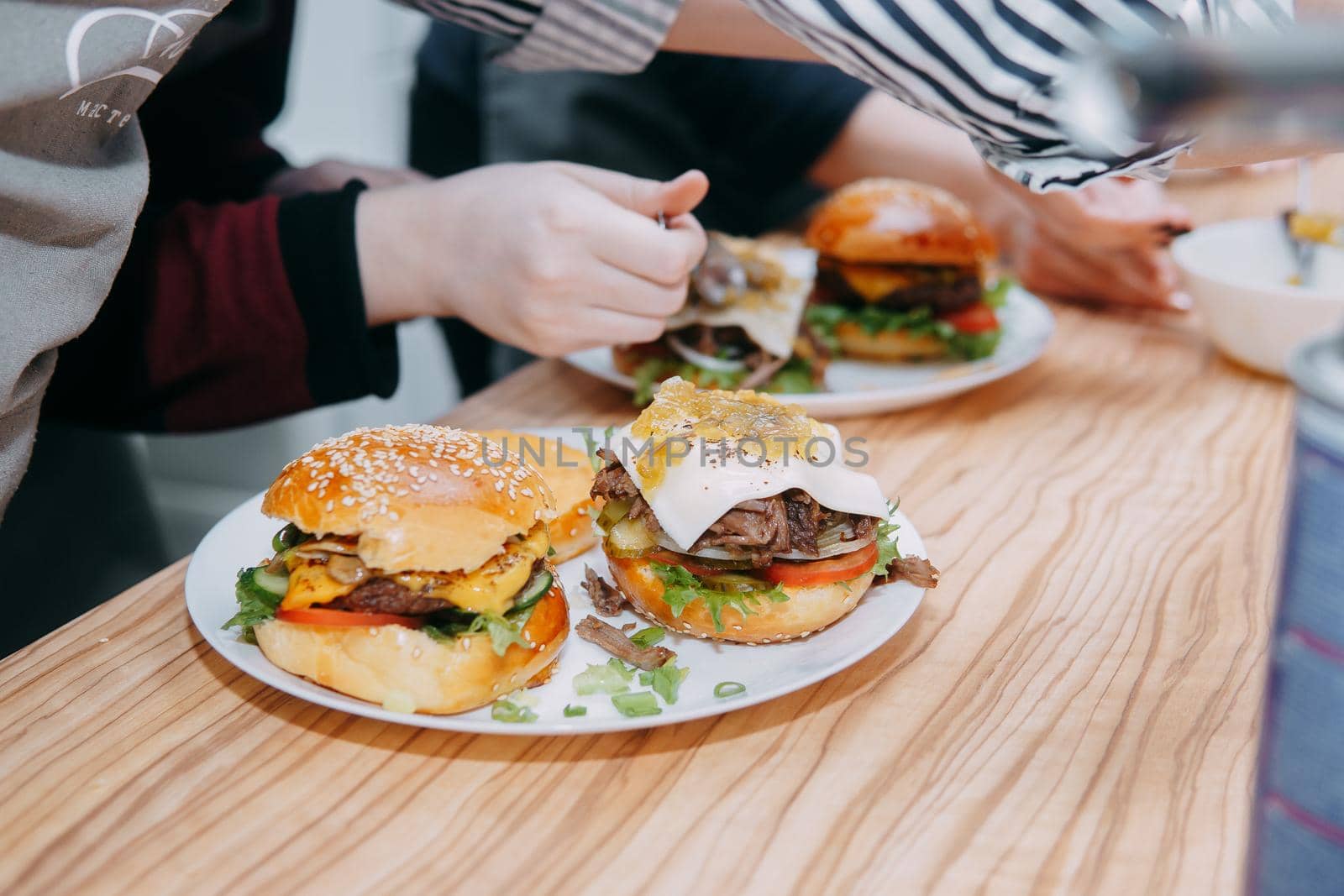 Burgers with beef and vegetables. Close up. Delicious burgers in a cooking class. Burger with cranberry sauce and Burger with onion sauce. home-made food, cooking at home
